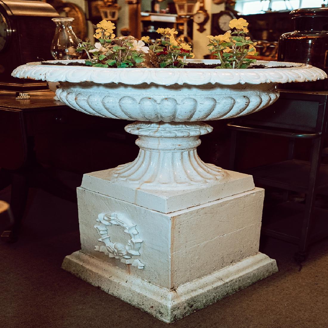 Pair of exceptional cast iron garden urns on pedestals.